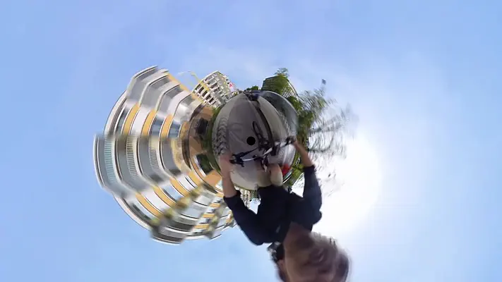 360 video 5 360-degree little planet with a curved apartment building, trees and sky.