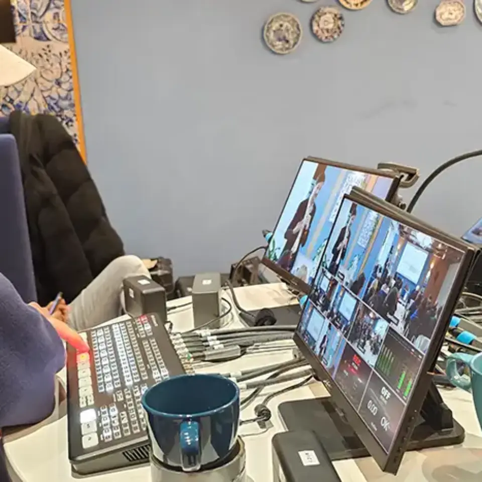 a woman sitting at a desk with a computer