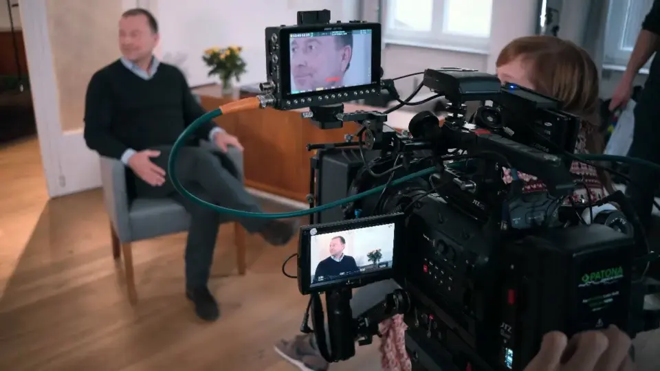 a man and woman on a video camera